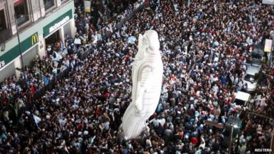 Aerial view of packed streets and inflatable Christ the Redeemer statue