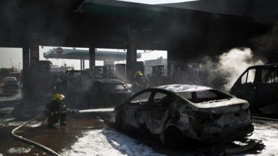 Israeli firefighters extinguish a fire that broke out after a rocket hit a petrol station in the southern city of Ashdod July 11, 2014
