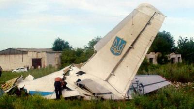 A picture taken on July 14, 2014 displays fragments of a Ukrainian AN-26 transport aircraft near the small eastern village of Davido-Nikolsk, in the Lugansk region, on July 14, 2014
