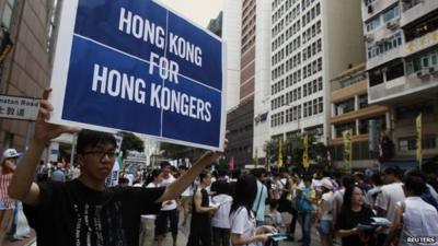 Protester holding sign reading 'Hong Kong for Hong Kongers', July 1, 2014