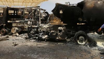 The wreckage of a truck and an airplane at Tripoli international airport