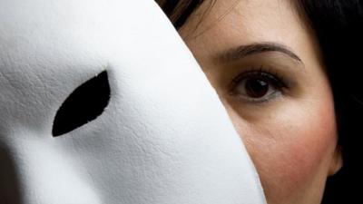 Woman holding mask