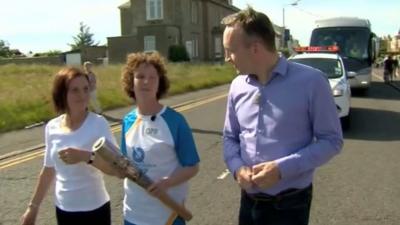 BBC reporter Graham Stewart with baton bearer Hazel McFarlane