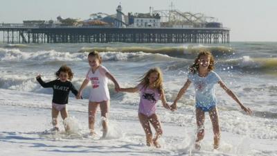 Four friends enjoy a splash around on Brighton beach
