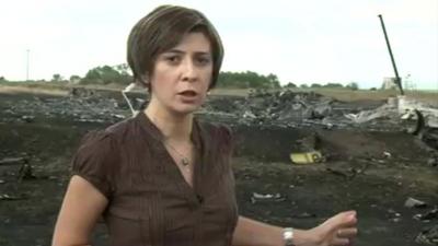 Natalia Antelava gestures towards crash site