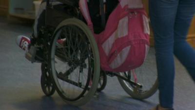 A wheelchair being pushed