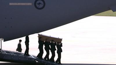 Coffin taken from plane