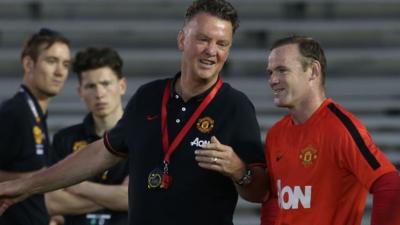 Manchester United manager Louis van Gaal teaches Wayne Rooney how to shoot