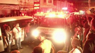 Ambulance in crowd near Qalandia checkpoint