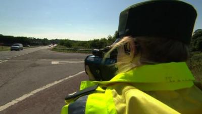 Policewoman with speed camera gun