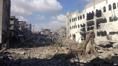 Resident in Shejaiya sift through rubble