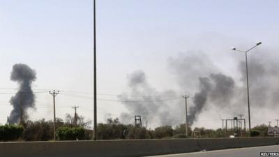 Smoke rises over the Airport Road area after heavy fighting between rival militias broke out near the airport in Tripoli on 25 July 2014.