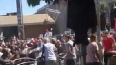 A bar stool is thrown during the violence in video. Video posted by Ian James