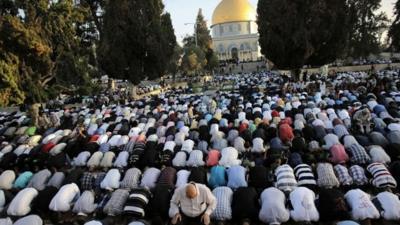 Muslim worshippers take part in a prayer in front of the Dome of the Rock during the holiday of Eid al-Fitr on the compound known to Muslims as al-Haram al-Sharif and to Jews as Temple Mount in Jerusalem"s Old City