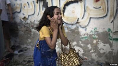 A Palestinian girl reacts at the scene of an explosion that medics said killed eight children and two adults