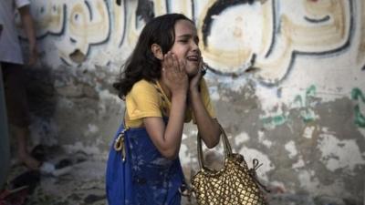 A Palestinian girl reacts at the scene of an explosion that medics said killed eight children and two adults