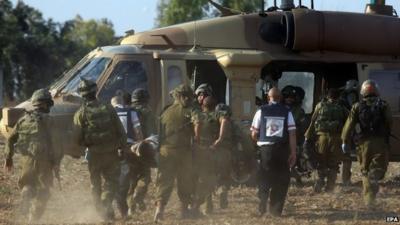 Israeli soldiers evacuate a wounded soldier
