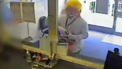 Man dressed as a clown robbing a currency exchange