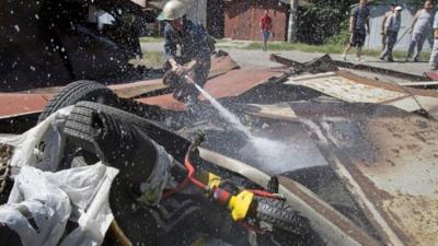 A fireman extinguishes a destroyed garage the after shelling in Donetsk