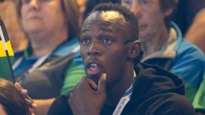 Usain Bolt watches netball at the Commonwealth Games