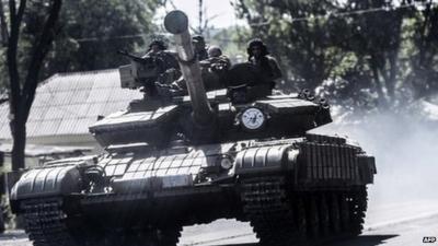 Pro-Russian militants sit on a tank in Donetsk, eastern Ukraine