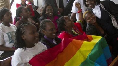 Gay community and rights activists smile in court