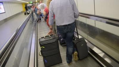 Passengers with luggage at Gatwick Airport