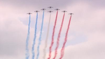 Planes trailing blue, white and red smoke