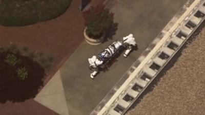 Health workers move a second US patient into a hospital