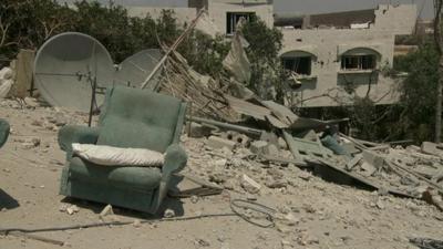 Armchair amidst the ruins of a house in Gaza