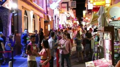 People on streets of Ibiza at night