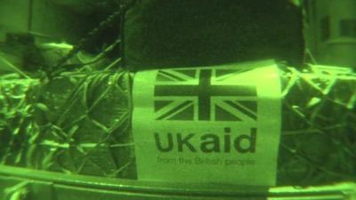 UK aid package in night vision on an RAF airplane