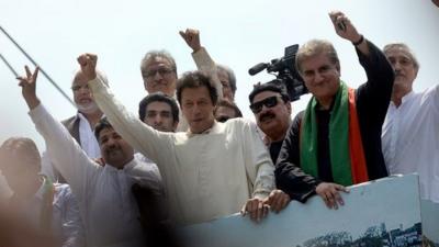 Imran Khan gestures as he heads a protest march from Lahore to Islamabad against the government, in Lahore on August 14, 2014