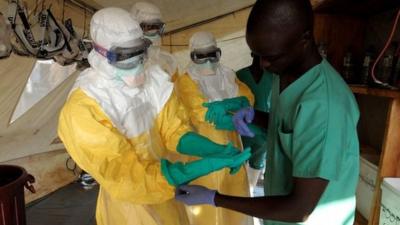 People wearing protective clothing in a West African country affected by the outbreak