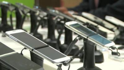 row of smartphones in a shop