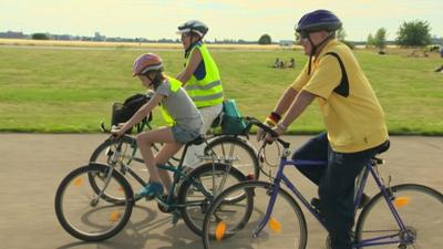 German mother and daughter cycling with 'adopted' grandfather