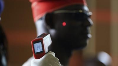 A man has his temperature taken using an infrared digital laser thermometer at the Nnamdi Azikiwe International Airport in Abuja, August 11, 2014