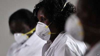 Kenyan health officials wait for airline passengers in Nairobi