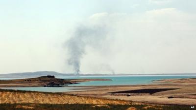 Smoke rises during airstrikes targeting Islamic State militants at the Mosul Dam outside Mosul, Iraq, Monday, Aug. 18, 2014