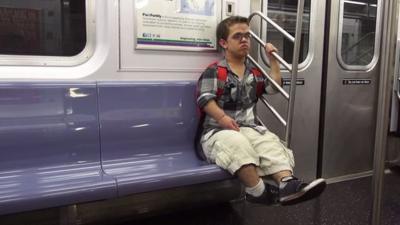 Filmmaker Jonathan Novick sitting on a train in New York