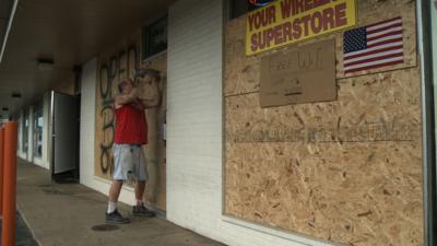 Man boarding up business