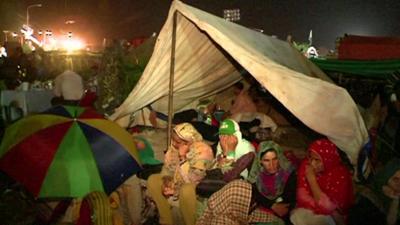 Protesters taking shelter in a makeshift tent outside Pakistan's parliament