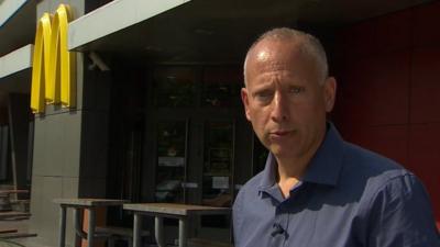 Steve Rosenberg outside empty McDonald's branch