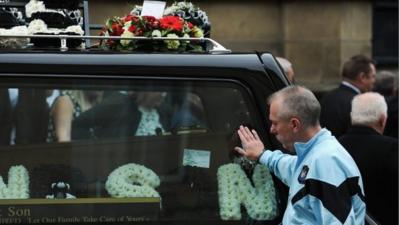 A member of the congregation pays his respects during the funeral of lifelong Newcastle United fan Liam Sweeney as it takes place at St Mary"s Cathedral on August 21, 2014 in Newcastle Upon Tyne, England