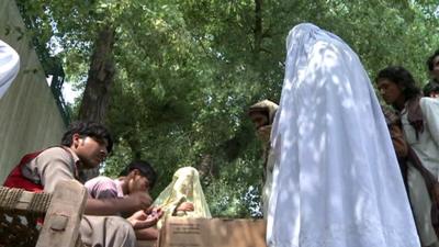 A female refugee collecting rations at the refugee camp in Bannu