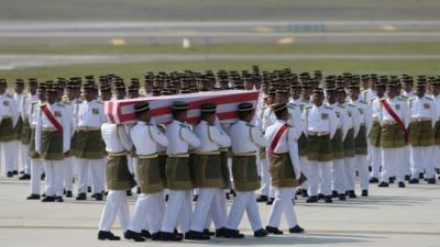 Coffins draped in the national flag were slowly carried to waiting hearses