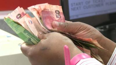 Counting cash in South Africa supermarket