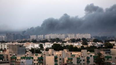 Smoke fills the sky over Tripoli after fighting between militias of Libya Fajr (Dawn of Libya) and Karama (Dignity) in Tripoli, Libya, 23 August 2014