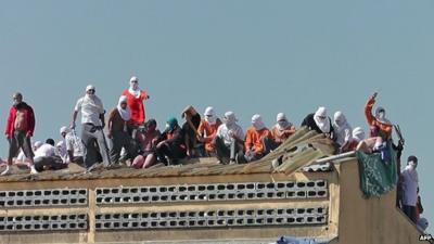 Inmates taking hostages on roof of a prison