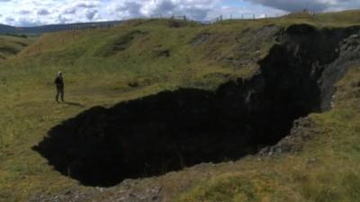 Landowner standing next to sink-hole